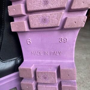 Simon’s black faux leather boots purple sole.